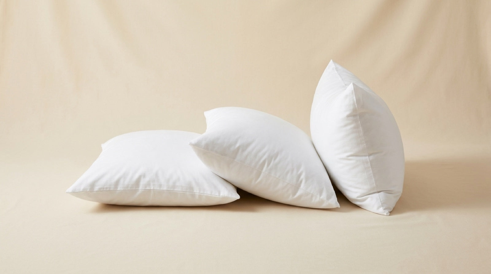 Three white hotel pillows in low, medium and high loft
