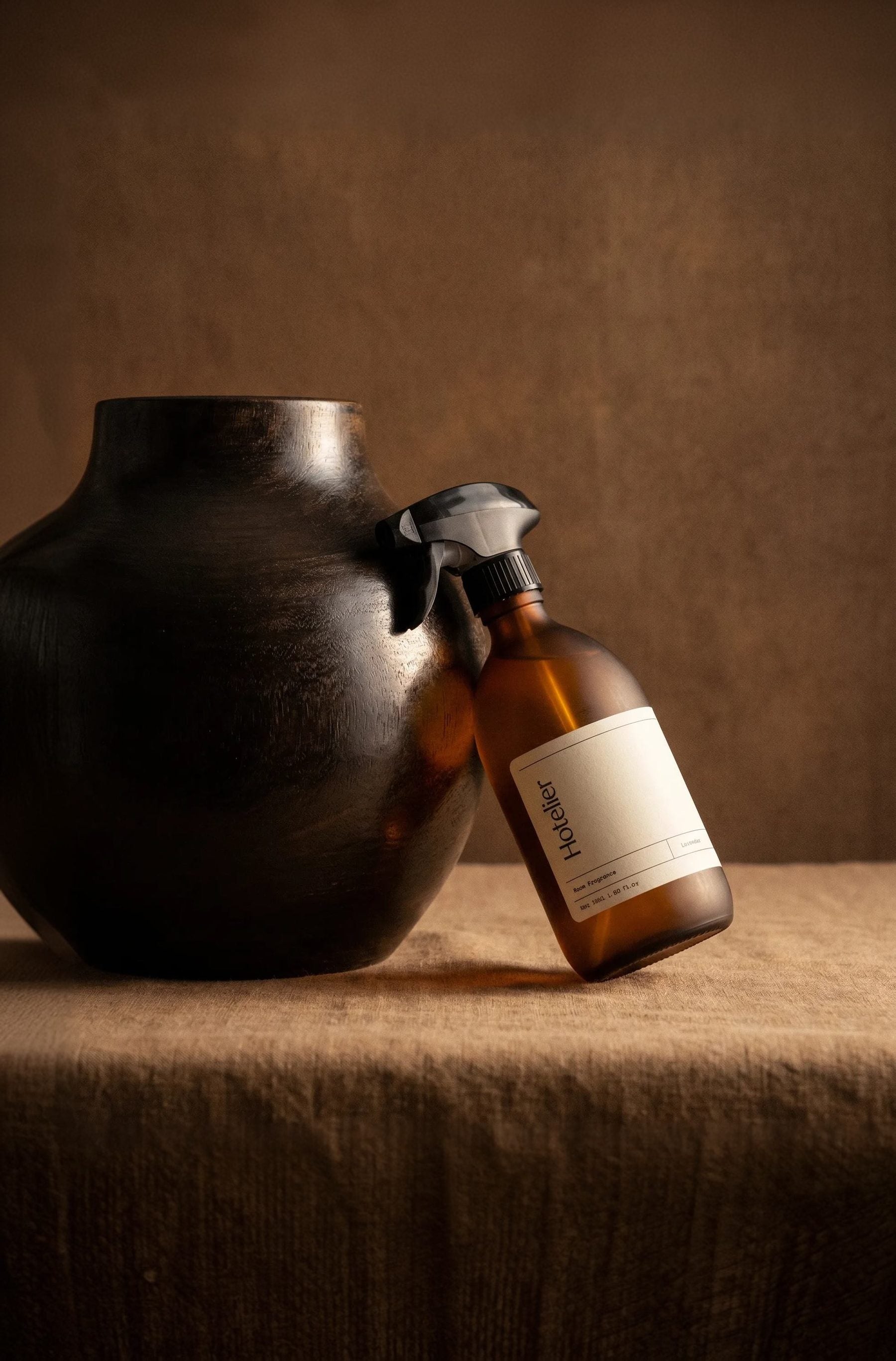Hotelier amber room fragrance bottle in warm light